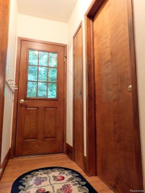 8750 Rucker Road Grosse Ile, MI 48138 - Photo 47 of 54 BASEMENT LANDING AREA WITH PANTRY, DOOR TO ATTACHED GARAGE AND FIBERGLASS SIDE ENTRY DOOR!