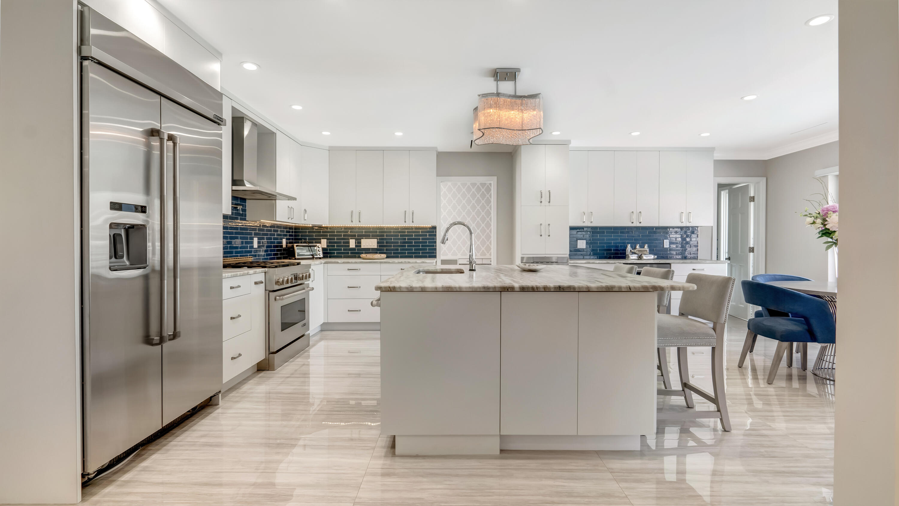 831 Dover Street Boca Raton, FL 33487 - Photo 23 of 71 a kitchen with stainless steel appliances kitchen island granite countertop a refrigerator and a stove top oven