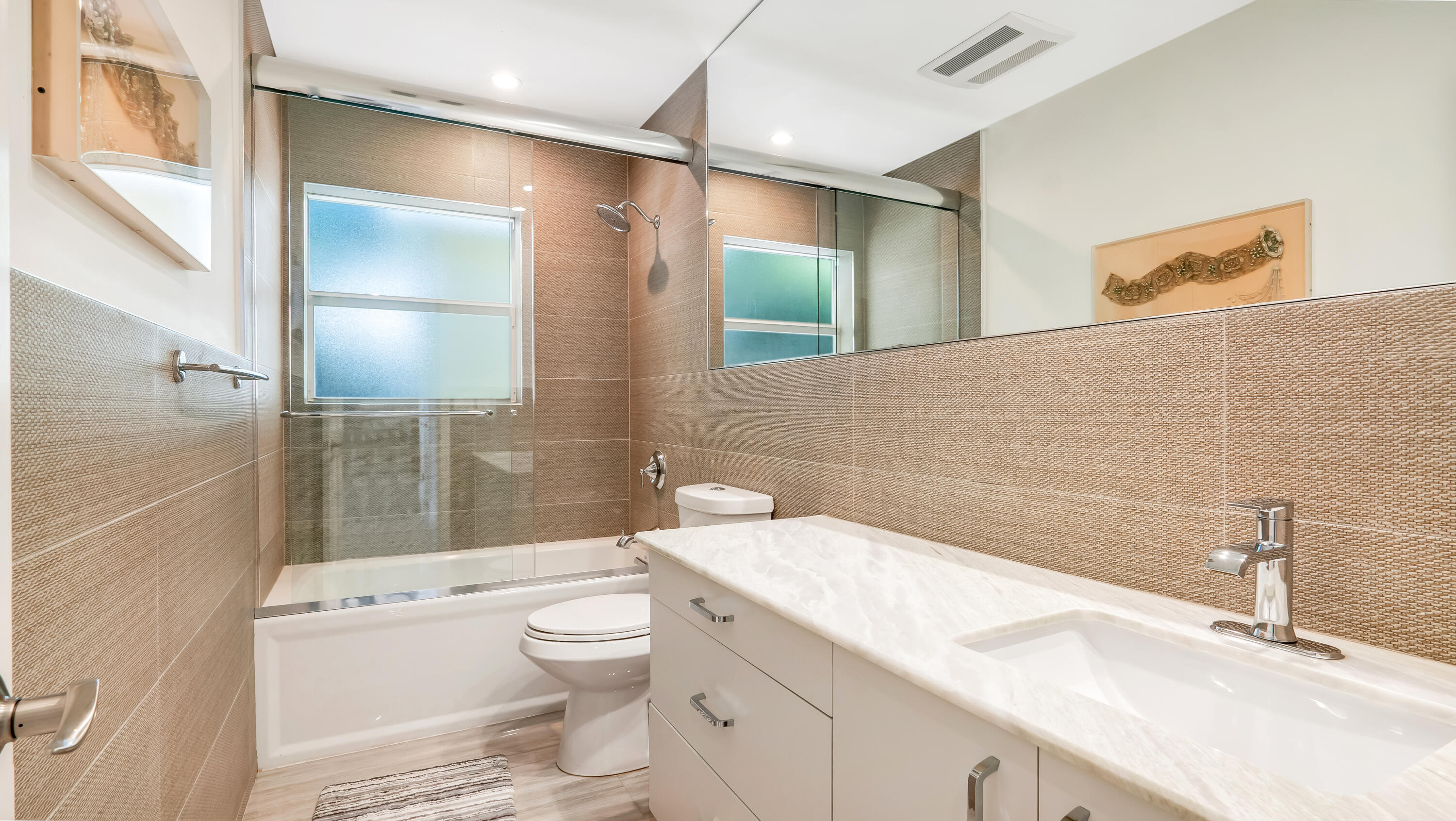 831 Dover Street Boca Raton, FL 33487 - Photo 42 of 71 a bathroom with a granite countertop sink a toilet and a large mirror