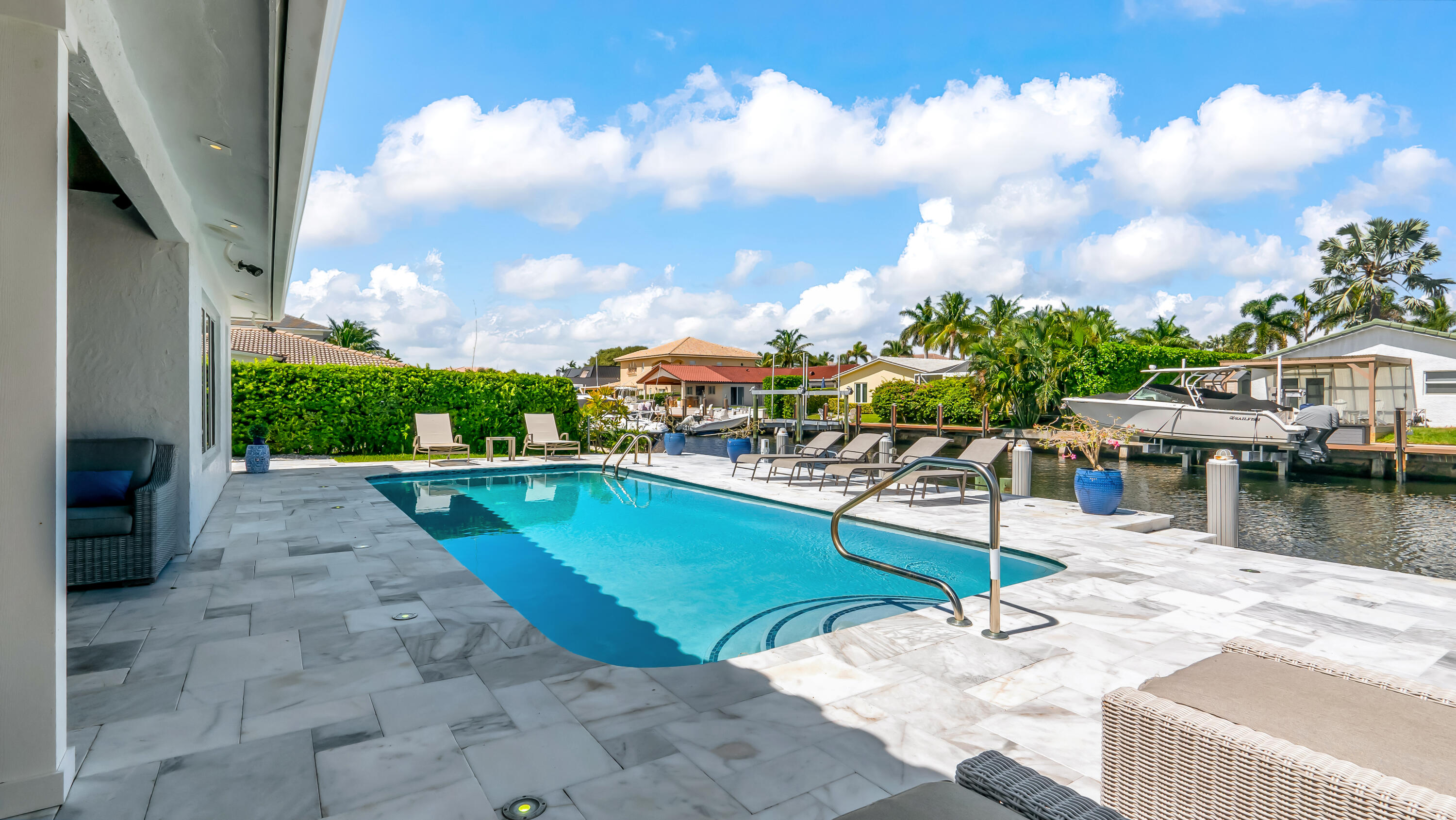 831 Dover Street Boca Raton, FL 33487 - Photo 58 of 71 a view of a swimming pool with a lounge chairs