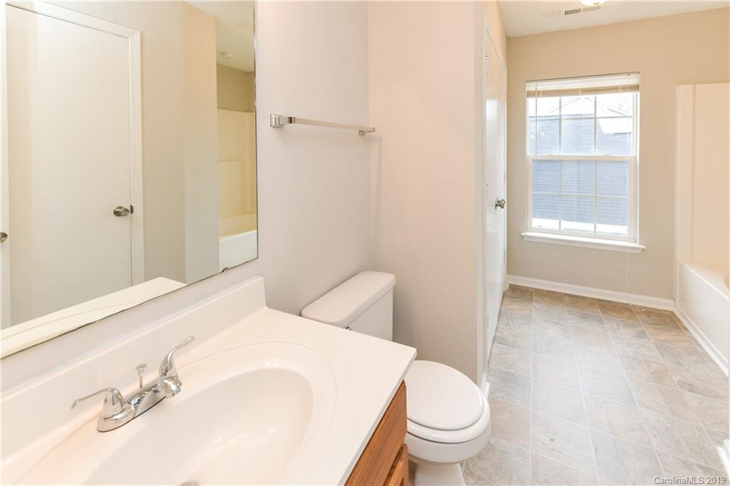 2031 Pimpernel Road Charlotte, NC 28213 - Photo 16 of 25 a bathroom with a sink a toilet and shower