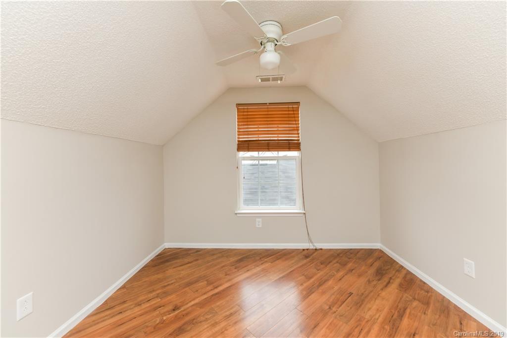 2031 Pimpernel Road Charlotte, NC 28213 - Photo 19 of 25 an empty room with a window and a chandelier fan