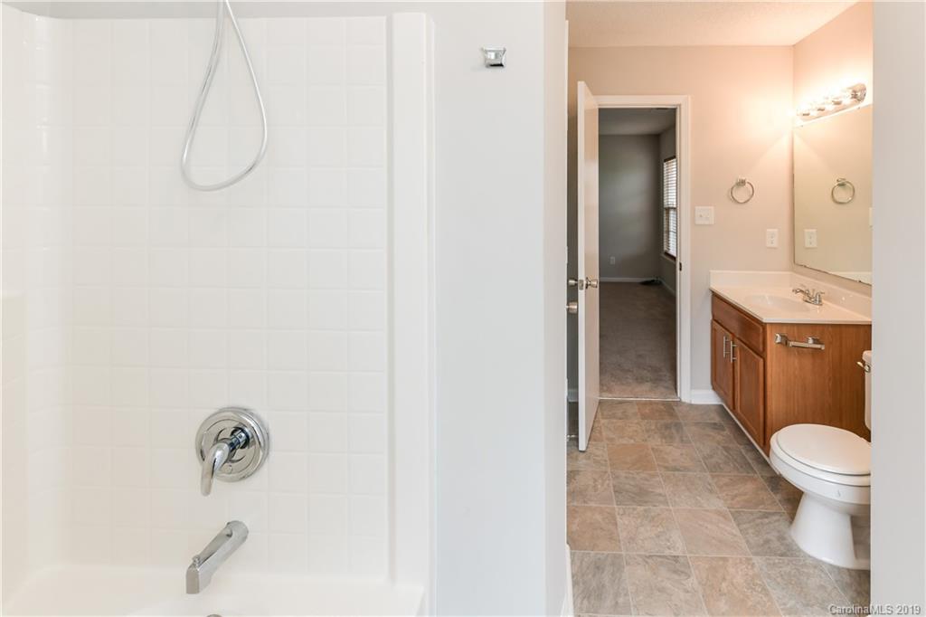 2031 Pimpernel Road Charlotte, NC 28213 - Photo 25 of 25 a bathroom with a granite countertop shower a toilet and sink