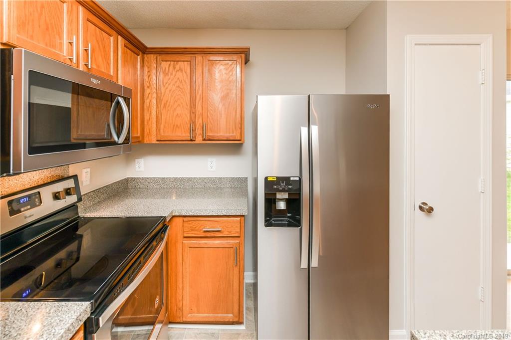 2031 Pimpernel Road Charlotte, NC 28213 - Photo 8 of 25 a kitchen with stainless steel appliances granite countertop a refrigerator a stove and a microwave