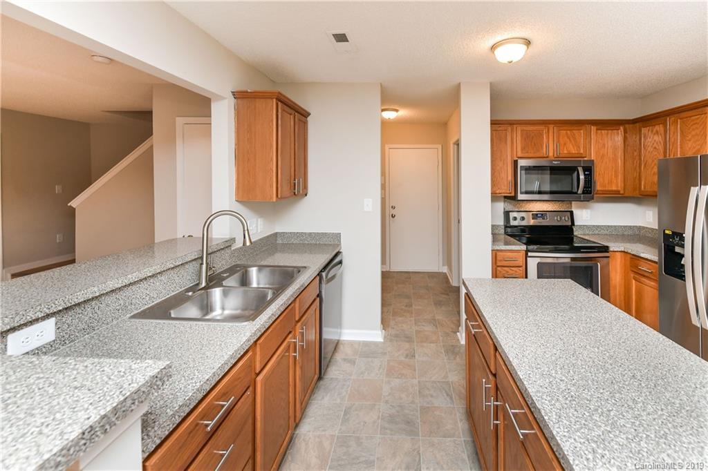 2031 Pimpernel Road Charlotte, NC 28213 - Photo 10 of 25 a kitchen with stainless steel appliances granite countertop a sink stove and refrigerator