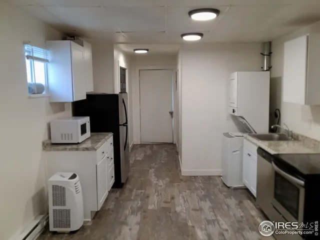 a view of a kitchen with electric appliances