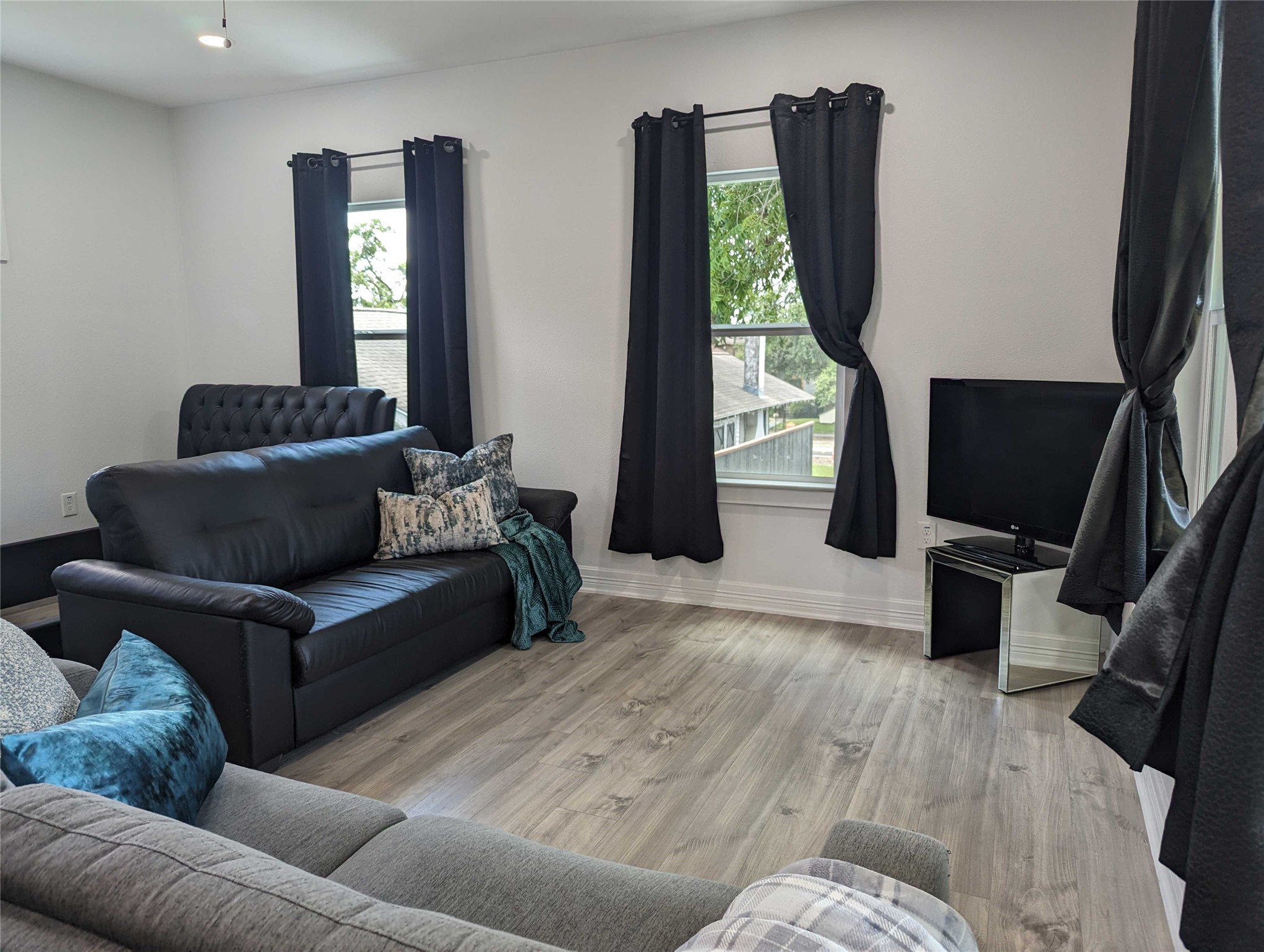 4711 Rusk Street, Unit A Houston, TX 77023 - Photo 3 of 19 a living room with furniture and a flat screen tv