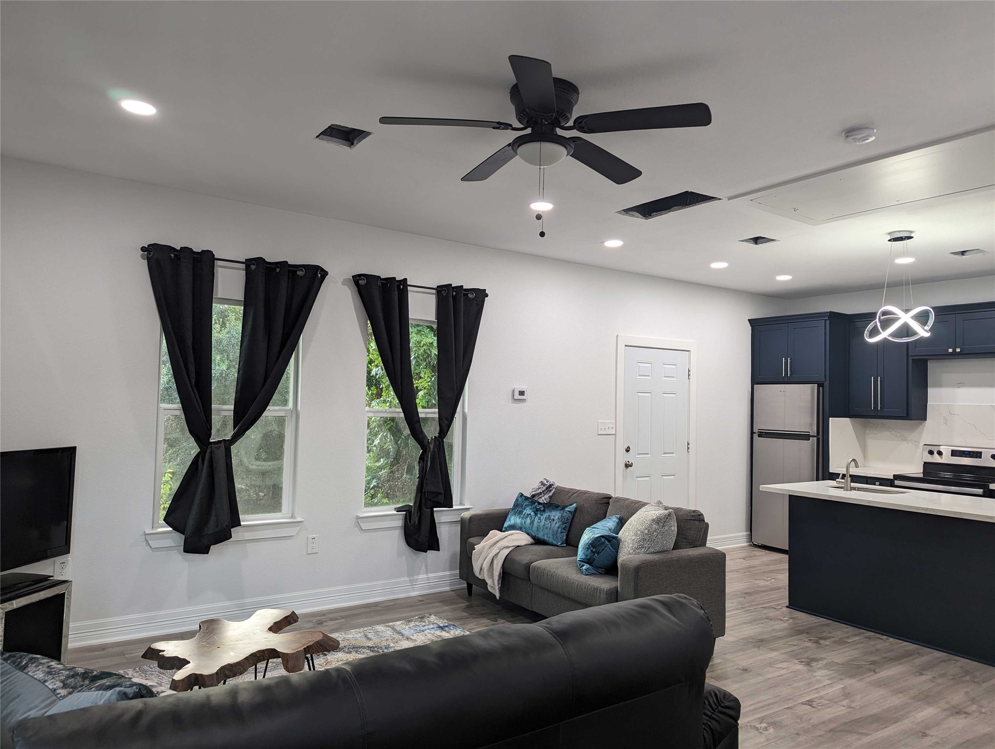 4711 Rusk Street, Unit A Houston, TX 77023 - Photo 5 of 19 a living room with furniture and a flat screen tv