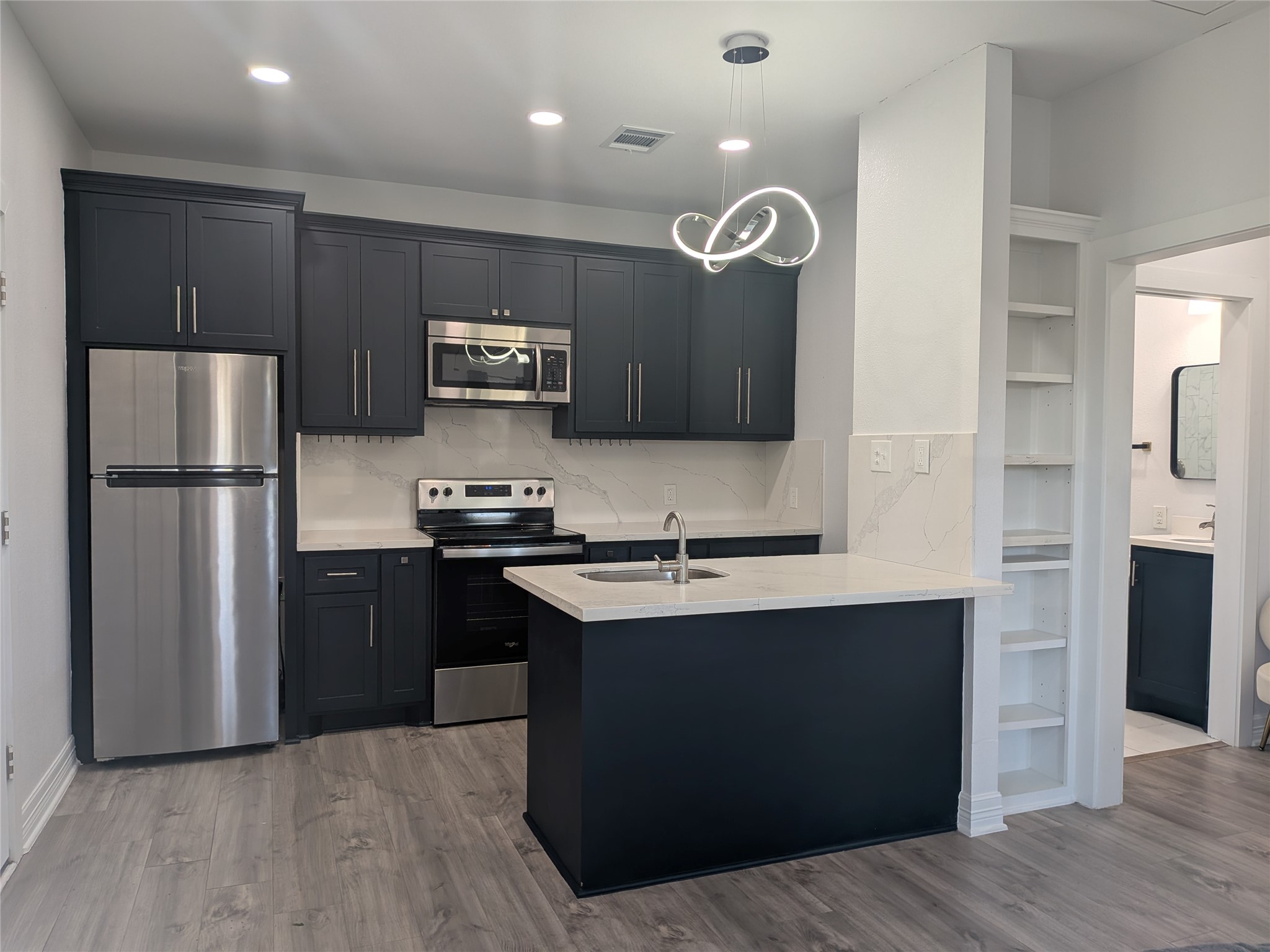 4711 Rusk Street, Unit A Houston, TX 77023 - Photo 6 of 19 a kitchen with a refrigerator a sink and cabinets