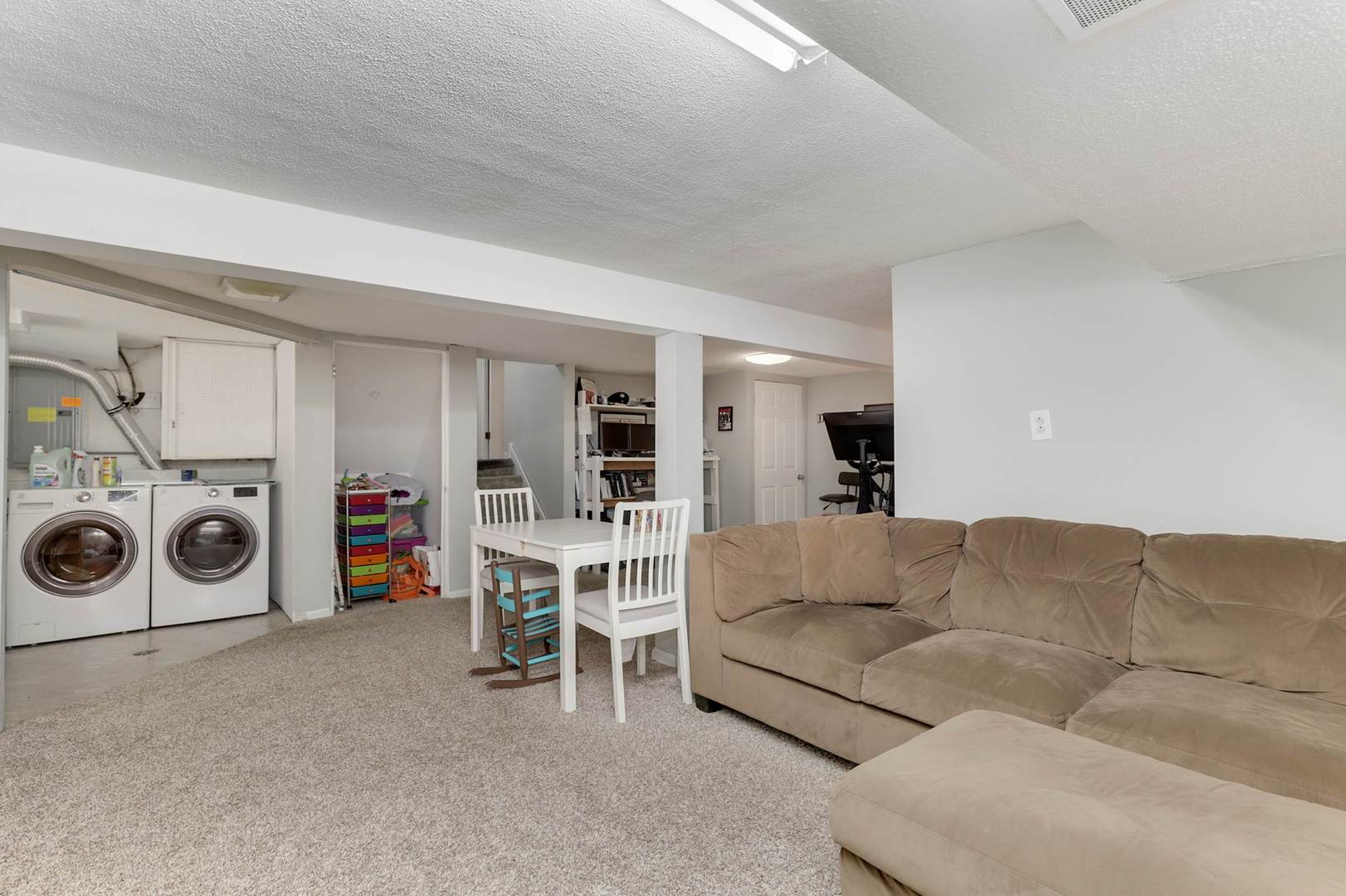 3906 Wolf Road Western Springs, IL 60558 - Photo 25 of 33 a living room with furniture and a washing machine