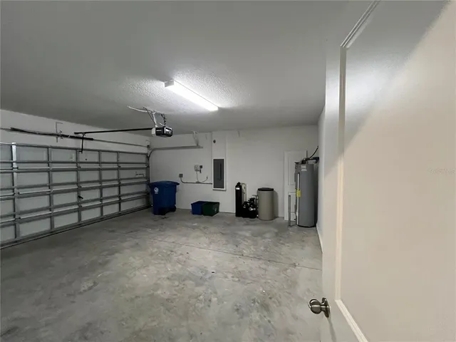 a view of an empty room with a chandelier fan