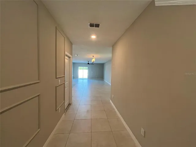 a view of a kitchen with a sink and a refrigerator