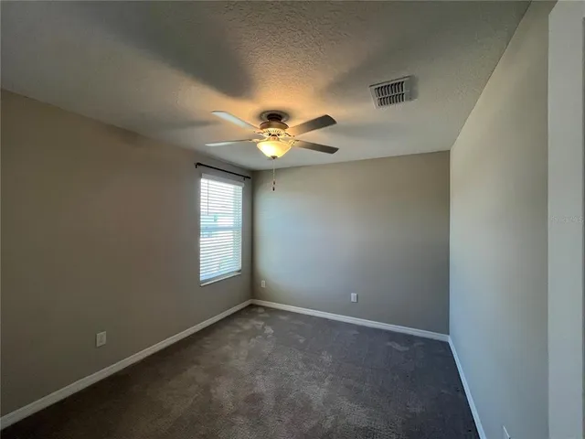 a bathroom with a granite countertop double vanity sink and mirror