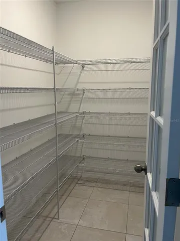 a view of backyard with wooden fence and trees