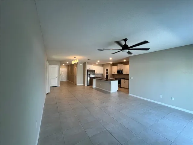a view of a kitchen with a sink and a refrigerator
