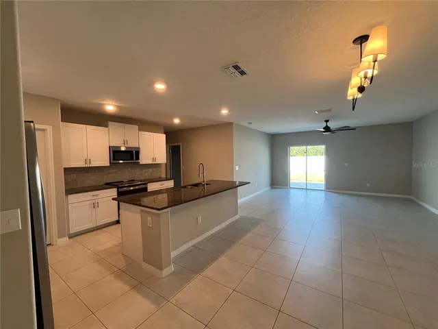 a kitchen with stainless steel appliances granite countertop a sink and cabinets