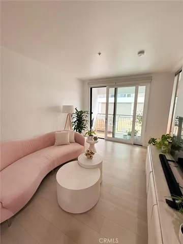 a view of a livingroom with furniture and a floor to ceiling window