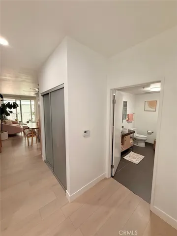 a bedroom with a bed a window and a flat screen tv