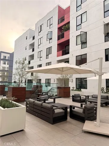 a view of a building and couches in the patio