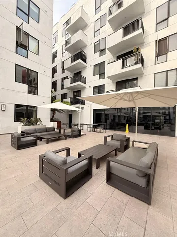 a swimming pool with couches and potted plants