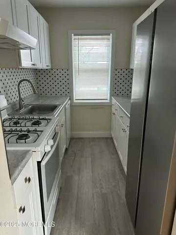 a kitchen with a sink stove and refrigerator