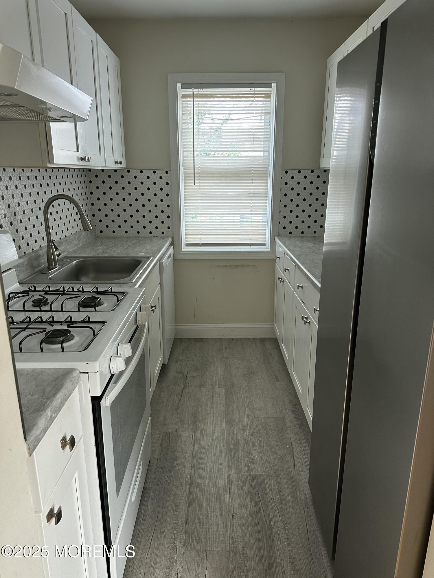31 Cedar Avenue, Unit 4 Long Branch, NJ 07740 - Photo 3 of 6 a kitchen with a sink stove and refrigerator