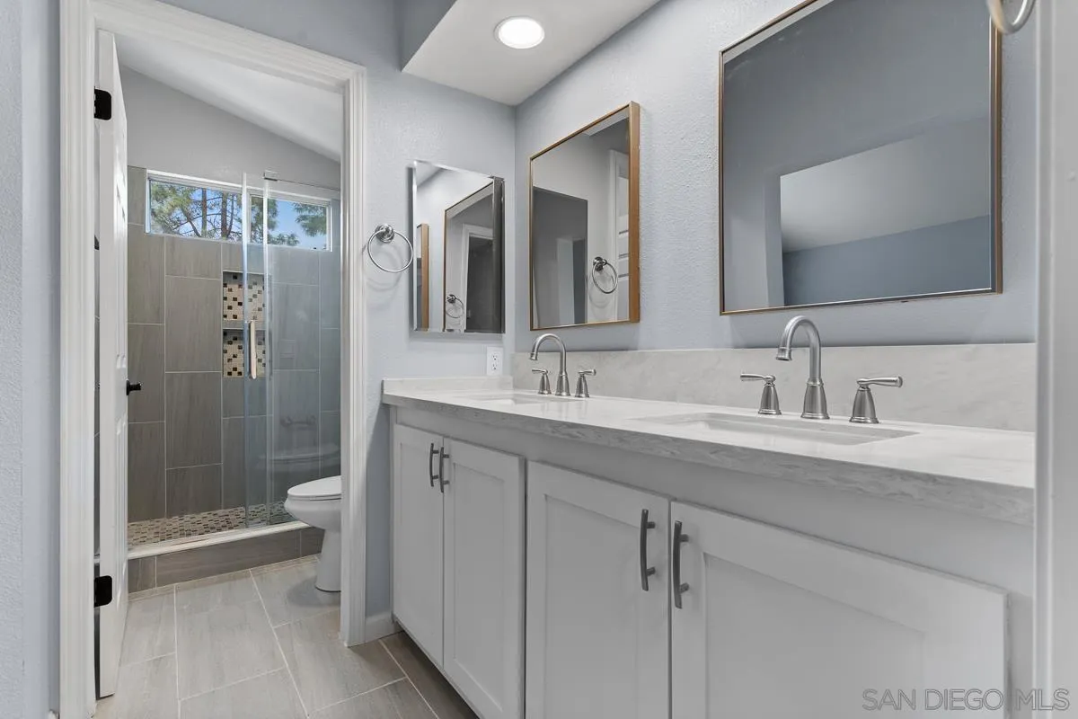13948 Carmel Ridge Road San Diego, CA 92128 - Photo 18 of 26 a bathroom with a sink a toilet and shower