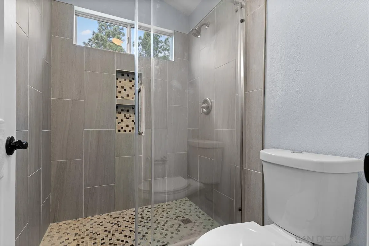 13948 Carmel Ridge Road San Diego, CA 92128 - Photo 19 of 26 a bathroom with a toilet and shower