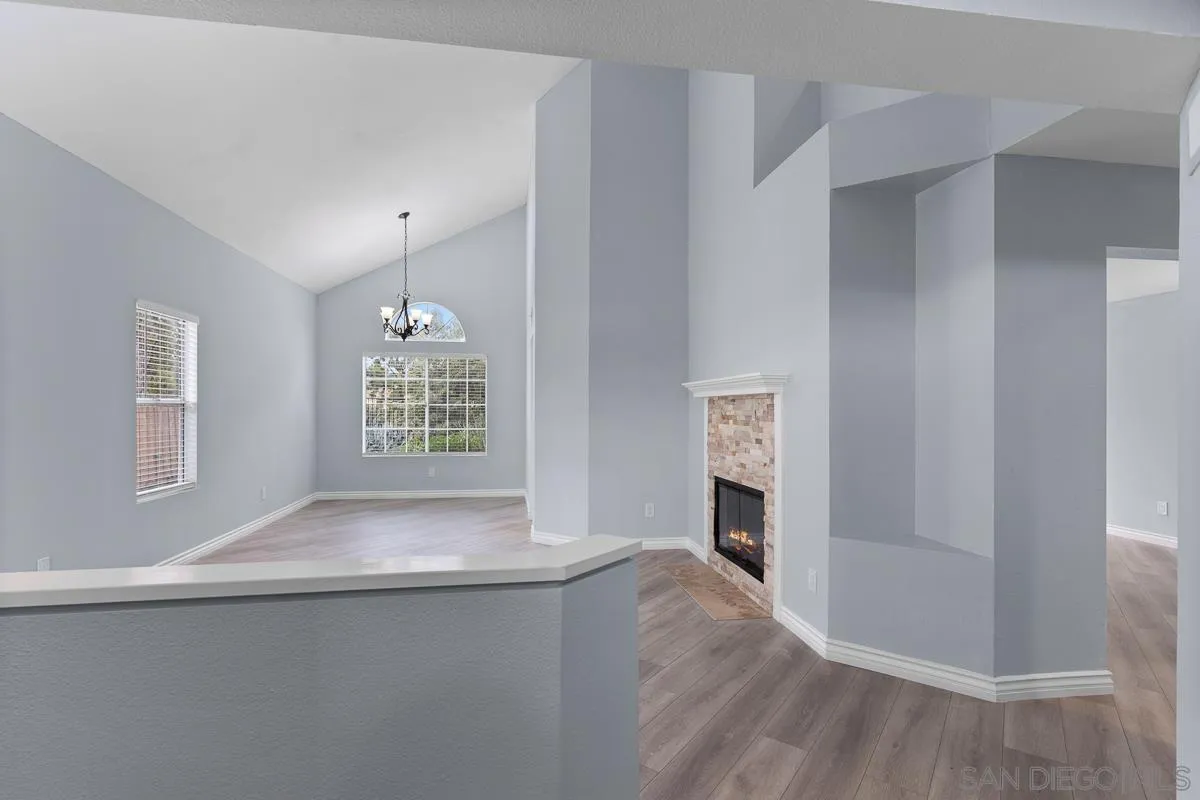 13948 Carmel Ridge Road San Diego, CA 92128 - Photo 2 of 26 a view of livingroom with hardwood floor and window