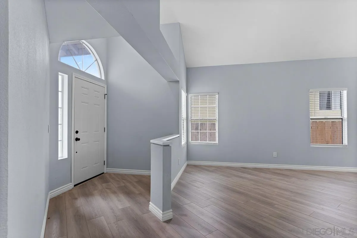 13948 Carmel Ridge Road San Diego, CA 92128 - Photo 3 of 26 an empty room with wooden floor and windows