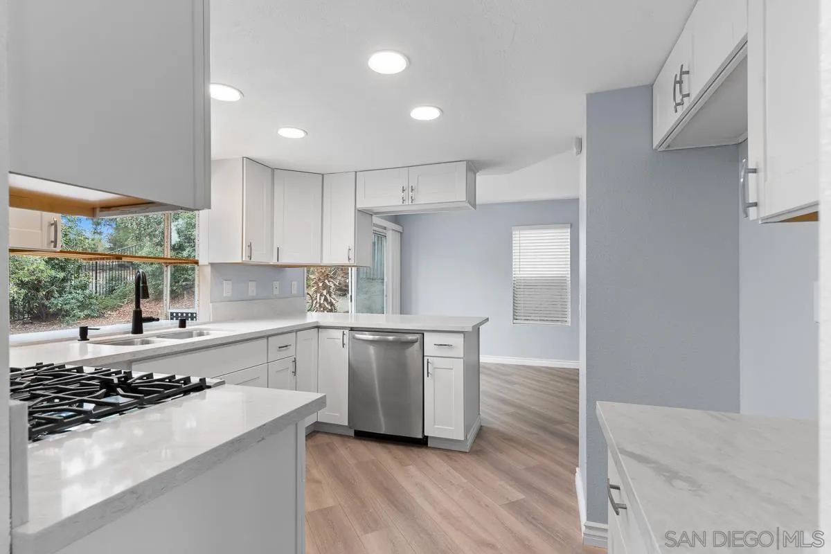 13948 Carmel Ridge Road San Diego, CA 92128 - Photo 6 of 26 a kitchen with a sink stove and refrigerator