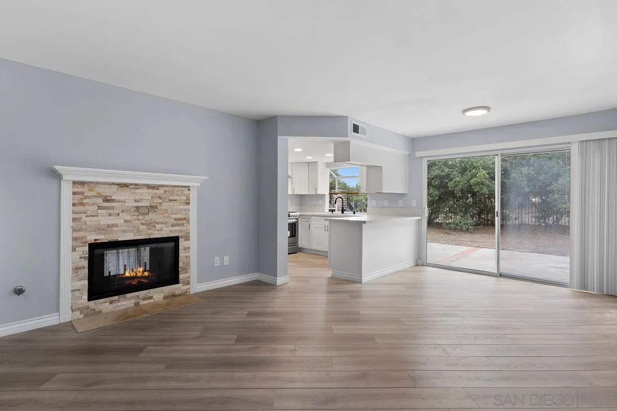 13948 Carmel Ridge Road San Diego, CA 92128 - Photo 10 of 26 a view of an empty room with a fireplace and window