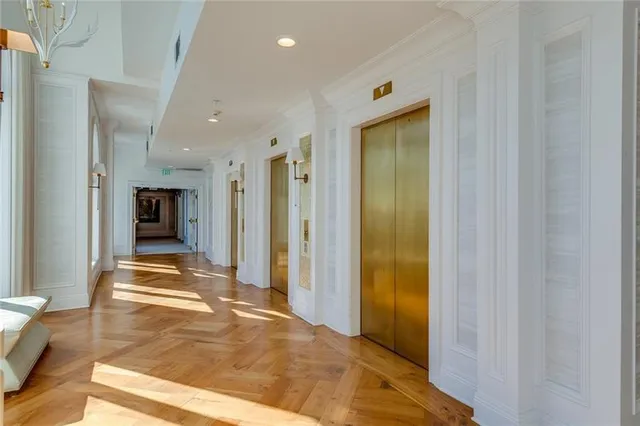 a view of a hallway with wooden shelves