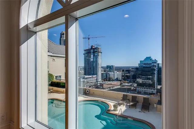 an outdoor space with swimming pool and furniture