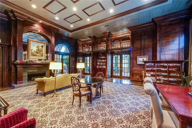 a living room with large windows and a chandelier