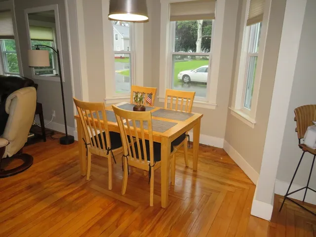 a view of a dining room with furniture and wooden floor