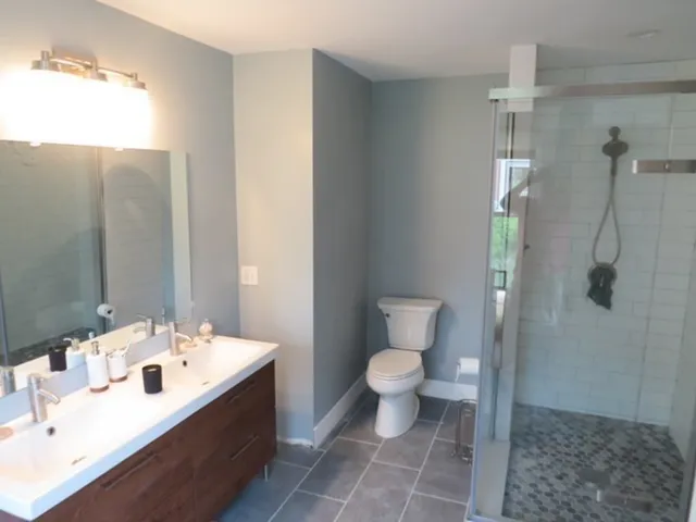 a bathroom with a sink toilet and shower