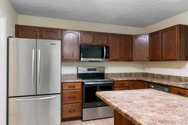 a kitchen with a refrigerator and a sink