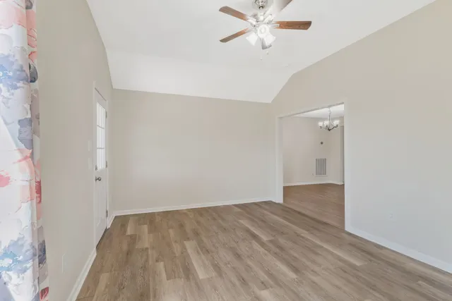 a view of a room with wooden floor