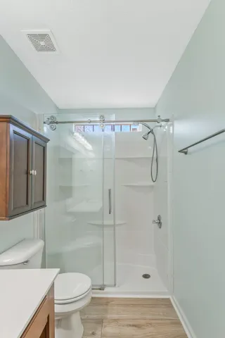 a bathroom with a shower and a toilet