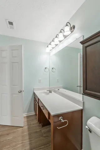 a room with a sink and wooden floor