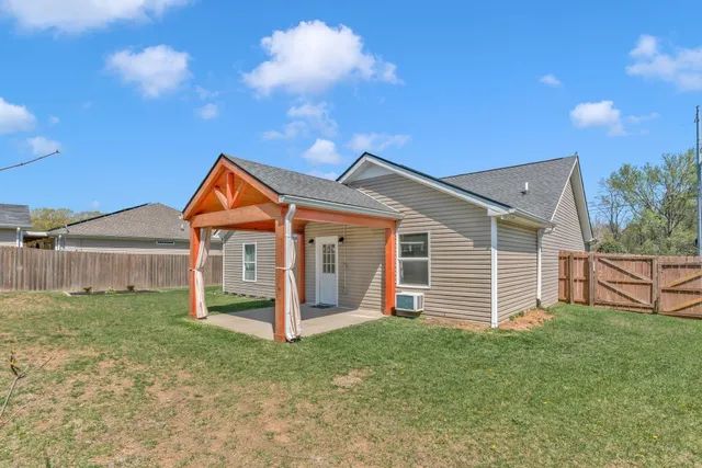 a view of a house with a yard and porch