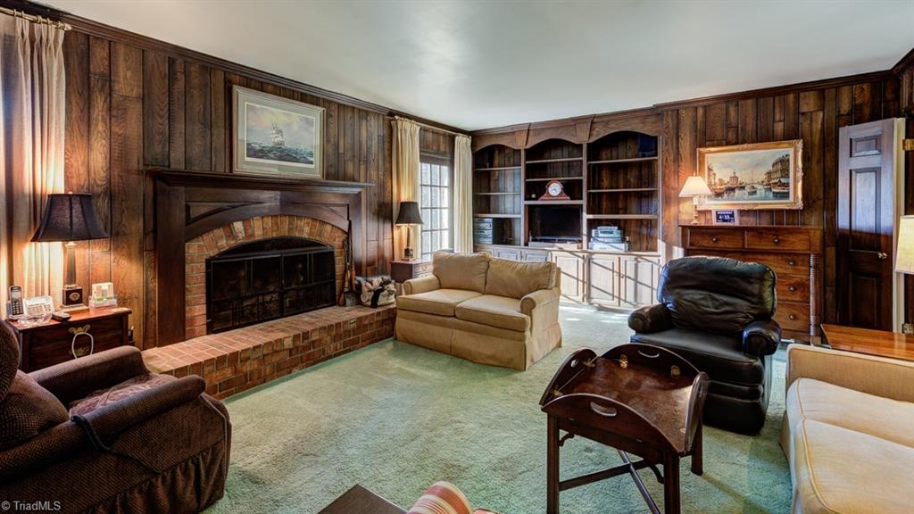 1415 Heathcliff Road High Point, NC 27262 - Photo 9 of 29 The second fireplace is in this warm and inviting den.