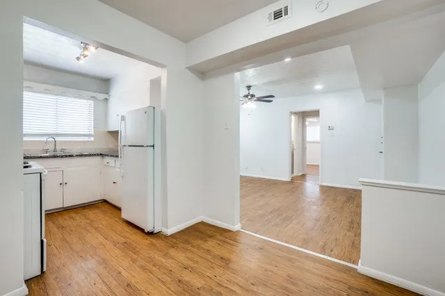 a view of a kitchen entryway with wooden floor