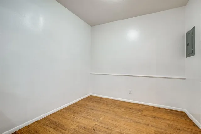 a view of a room with wooden floor