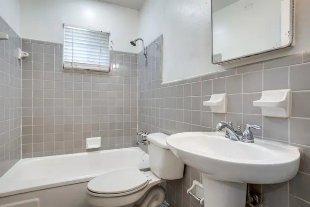 a bathroom with a sink a toilet and bathtub