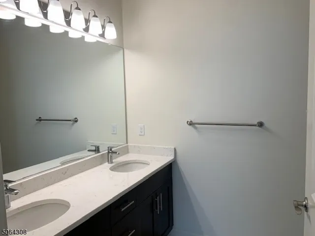 a bathroom with a sink vanity and a mirror