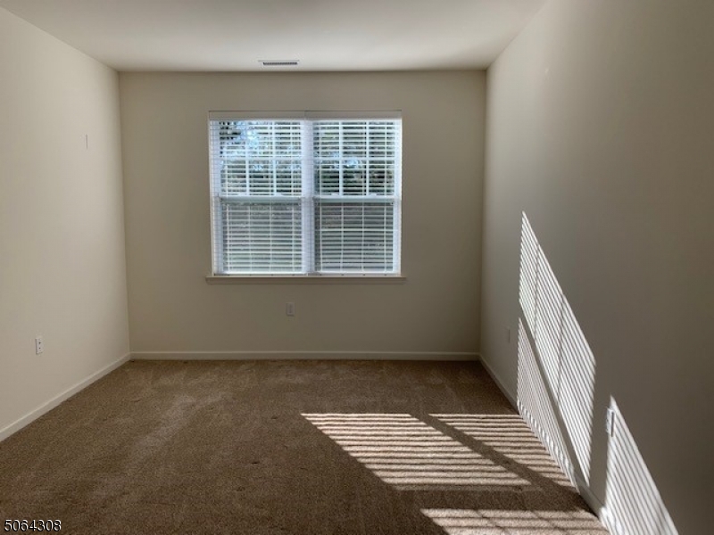 60 Passaic Avenue, Unit 20 Fairfield, NJ 07004 - Photo 10 of 13 an empty room with a window