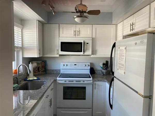 a kitchen with stainless steel appliances a stove sink and refrigerator