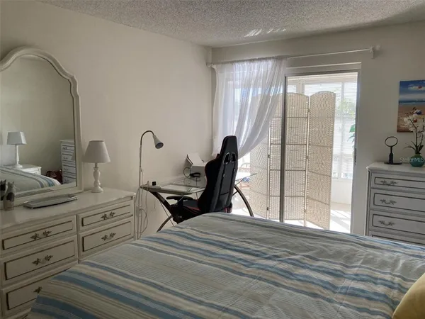 a bedroom with a bed and a dresser in it